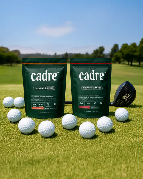 Cadre Creatine Gummies bags for Orange Creamsicle and Watermelon flavors on golf course surrounded by golf balls and driver, symbolizing focus, energy, and all-day consistency.
