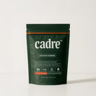 Cadre Orange Creamsicle Creatine Gummies bag on white background, premium matte green packaging with orange accent.
